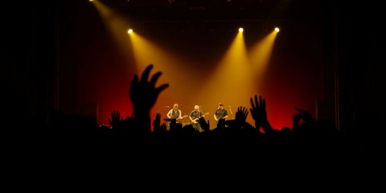A vibrant crowd enjoying a live band on stage.