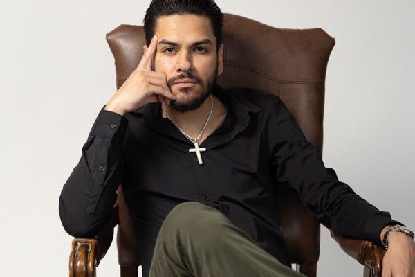 "This image captures Virlán García at the launch of his album Mi Entorno, showcasing his pride in his roots and inviting fans to experience the personal stories and sounds reflected in his music."